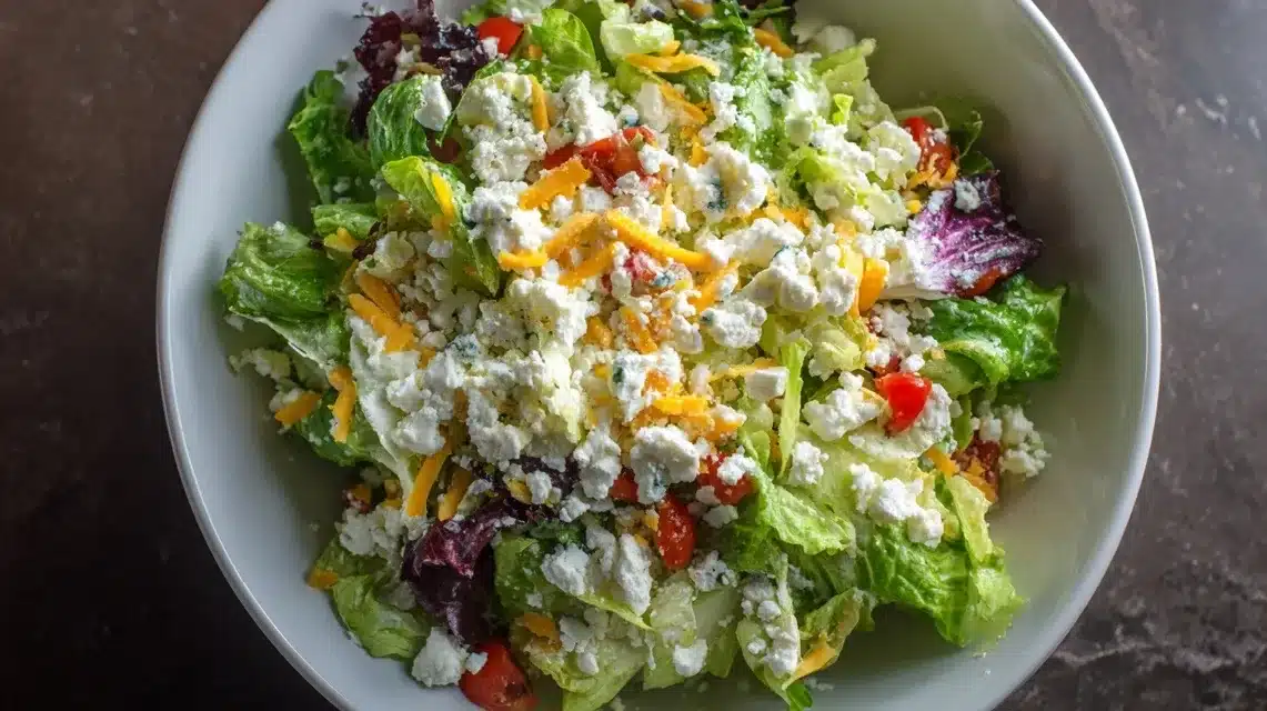 Chicken tender salad with crumbled feta on top