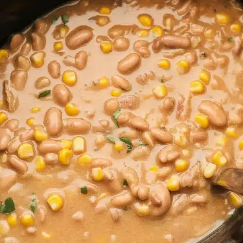 Bowl of creamy White Chicken Chili made in a Slow Cooker with chicken, beans, and spices.