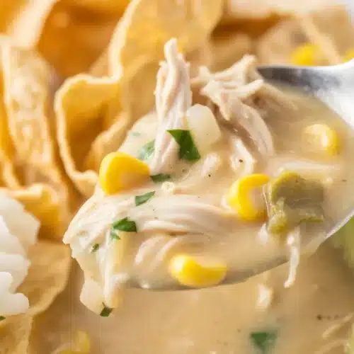 Creamy White Chicken Chili made in a Crockpot with beans, chicken, and spices.