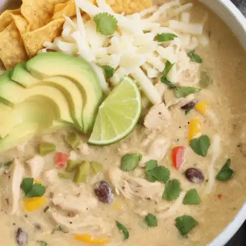 Bowl of easy White Chicken Chili with shredded chicken, beans, and spices.