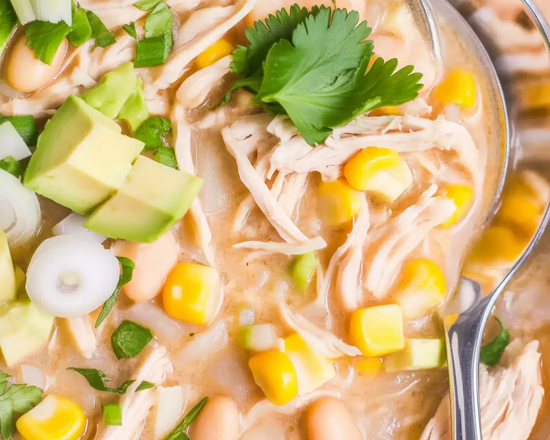 Delicious Instant Pot White Chicken Chili topped with green onions and served in a bowl.
